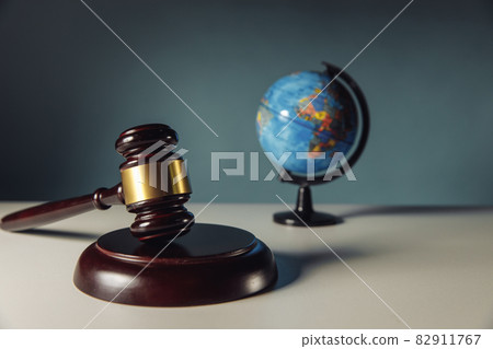 Concept of world justice. Wooden judge gavel and globe Concept of world justice. Wooden judge gavel and globe 82911767