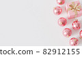 Pink gift boxes with golden ribbon and baubles on white background, 3d render 82912155