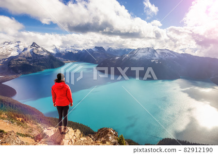 Adventurous Caucasian Woman hiking on top of a Canadian mountain. Adventurous Caucasian Woman hiking on top of a Canadian mountain. 82912190
