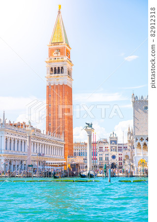 Venice historical center waterfront with St Mark Campanile, Italian: Campanile di San Marco. Sunny summer day in Venice, Italy. Venice historical center waterfront with St Mark Campanile, Italian: Campanile di San Marco. Sunny summer day in Venice, Italy. 82912318