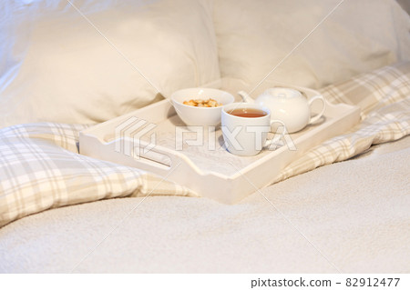 morning breakfast at bed - striped teaset on breakfast tray in bedroom morning breakfast at bed - striped teaset on breakfast tray in bedroom 82912477
