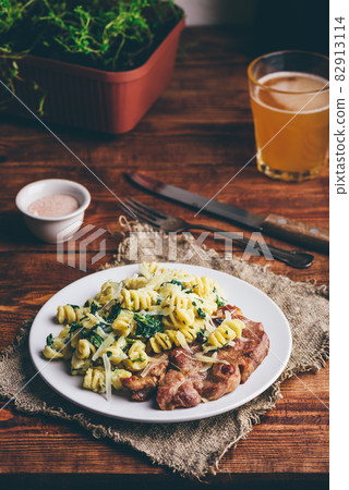 Pork Steak and Creamy Pasta with Spinach Pork Steak and Creamy Pasta with Spinach 82913114