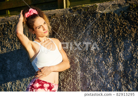 portrait of a young Hispanic woman in sportswear, ready to play sports outdoors. 82913295