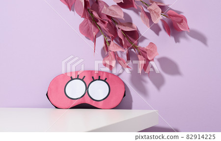 pink textile sleep mask on white table pink textile sleep mask on white table 82914225