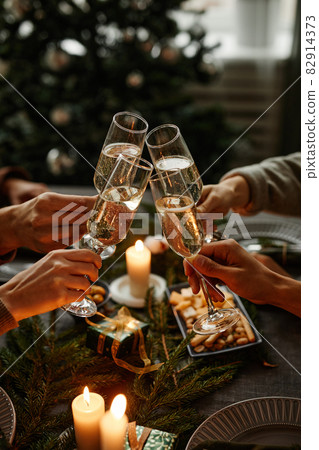 Clinking Glasses at Christmas Dinner Clinking Glasses at Christmas Dinner 82914373