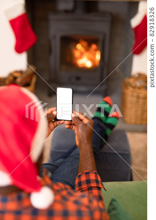 Back view of african american senior man using smartphone with copy space at christmas time 82918326
