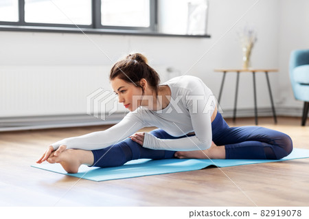 young woman doing yoga exercise at home young woman doing yoga exercise at home 82919078