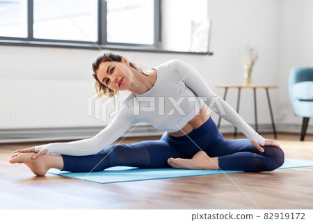 young woman doing yoga exercise at home 82919172