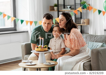 happy family with birthday cake at home 82919209