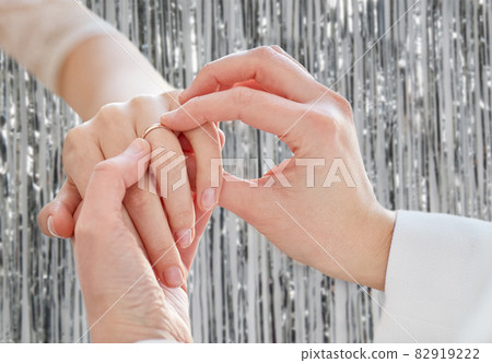 close up of lesbian couple hands with wedding ring close up of lesbian couple hands with wedding ring 82919222