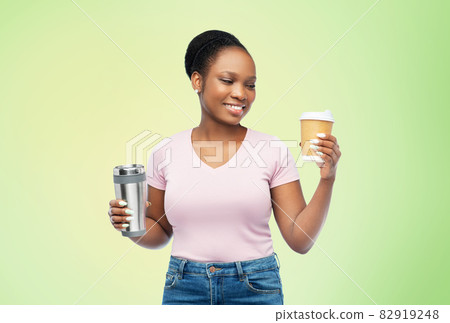 woman with coffee cup and tumbler for hot drinks 82919248