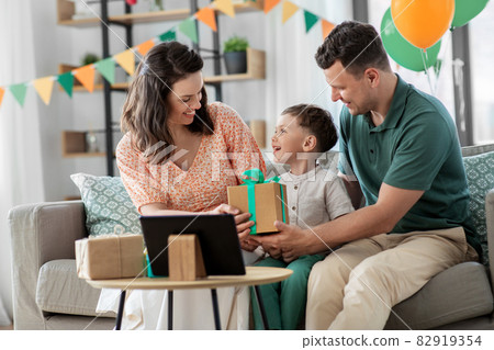 happy family giving present to little son at home 82919354