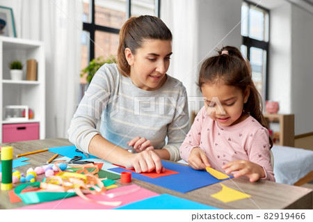 daughter with mother making applique at home 82919466