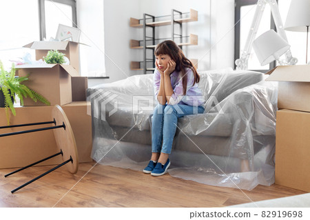 sad asian woman with stuff moving to new home sad asian woman with stuff moving to new home 82919698