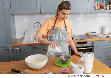 woman cooking food and baking on kitchen at home woman cooking food and baking on kitchen at home 82919769