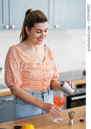 woman making cocktail drinks at home kitchen woman making cocktail drinks at home kitchen 82919991