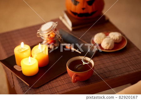 mesh tea infuser ball in ceramic mug on halloween 82920167