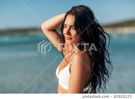 beautiful young woman in bikini swimsuit on beach beautiful young woman in bikini swimsuit on beach 82920225