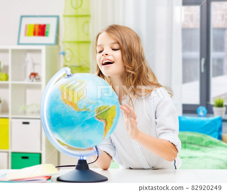 smiling student girl with globe at home smiling student girl with globe at home 82920249
