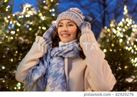 happy woman walking in christmas city in winter happy woman walking in christmas city in winter 82920276