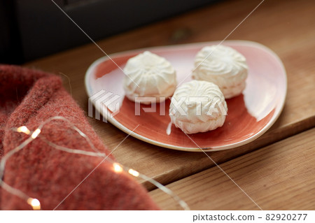 meringue on ceramic plate on window sill meringue on ceramic plate on window sill 82920277