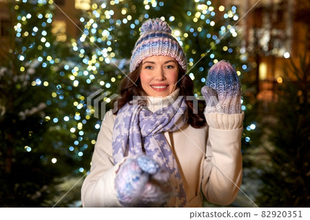 happy woman taking christmas selfie on street happy woman taking christmas selfie on street 82920351