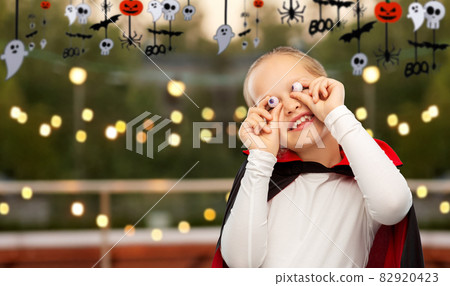girl in halloween costume of dracula with eyeballs girl in halloween costume of dracula with eyeballs 82920423