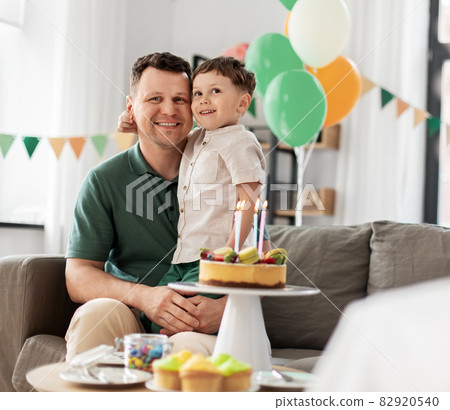 happy father and son with birthday cake at home 82920540