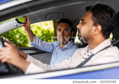 car driving school instructor teaching male driver car driving school instructor teaching male driver 82920580