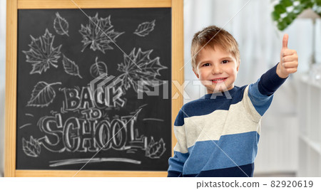 little student boy showing thumbs up little student boy showing thumbs up 82920619