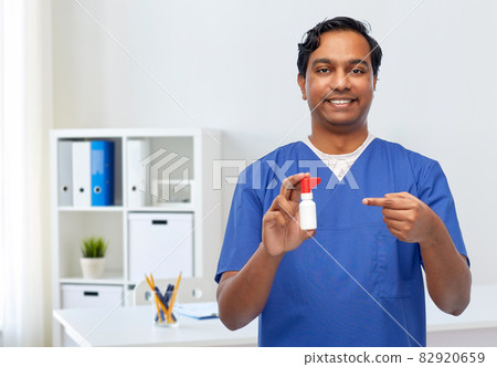 smiling indian male doctor or nurse with medicine smiling indian male doctor or nurse with medicine 82920659