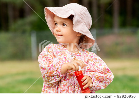 happy baby girl with soap bubble blower in summer happy baby girl with soap bubble blower in summer 82920956