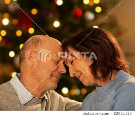 senior couple touching foreheads on christmas 82921153