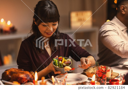 happy woman with friends having christmas dinner happy woman with friends having christmas dinner 82921184