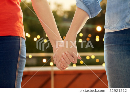 close up of female gay couple holding hands close up of female gay couple holding hands 82921212
