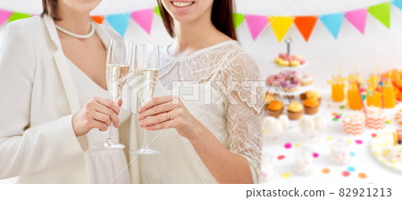 close up of female gay couple with champagne close up of female gay couple with champagne 82921213