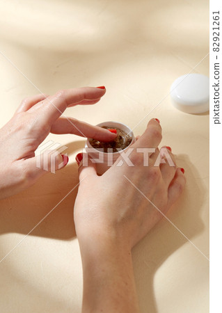 close up of hands with natural body scrub in jar 82921261