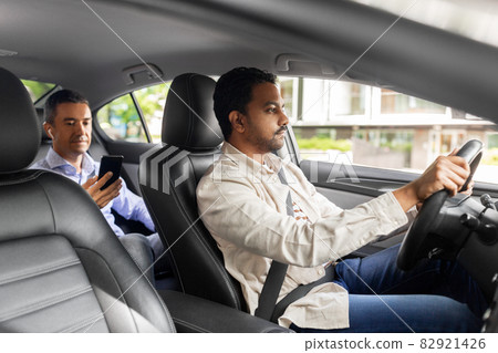 male passenger with smartphone in taxi car 82921426