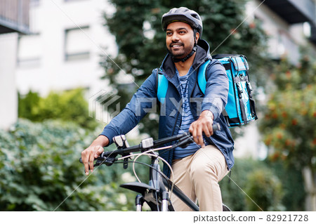 indian delivery man with bag riding bicycle indian delivery man with bag riding bicycle 82921728