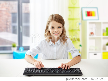 happy student girl with keyboard at home happy student girl with keyboard at home 82921749