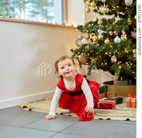 happy baby girl with christmas gifts at home 82921846