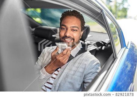 male passenger calling on smartphone in taxi car 82921878