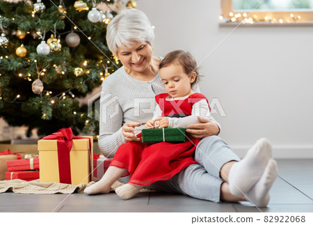 grandmother and baby girl with christmas gifts grandmother and baby girl with christmas gifts 82922068