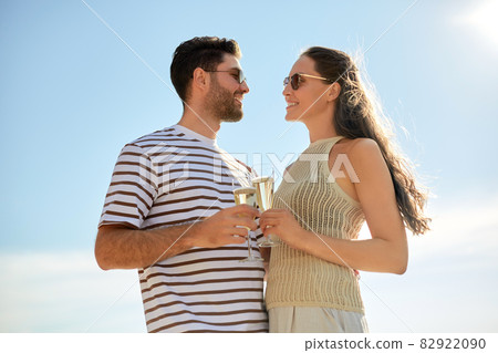 happy couple drinking champagne in summer 82922090