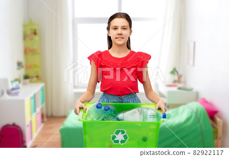 smiling girl sorting plastic waste 82922117
