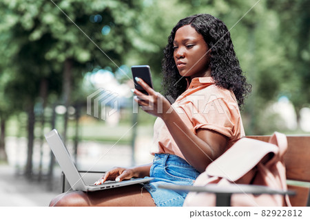 african student girl with laptop and smartphone african student girl with laptop and smartphone 82922812