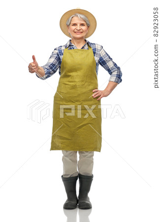 senior woman in garden apron showing thumbs up 82923058