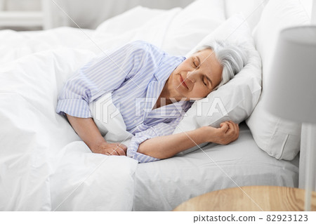 senior woman sleeping in bed at home bedroom senior woman sleeping in bed at home bedroom 82923123
