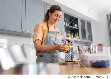 happy young woman cooking food on kitchen at home happy young woman cooking food on kitchen at home 82923201