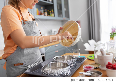 woman cooking food and baking on kitchen at home woman cooking food and baking on kitchen at home 82923204